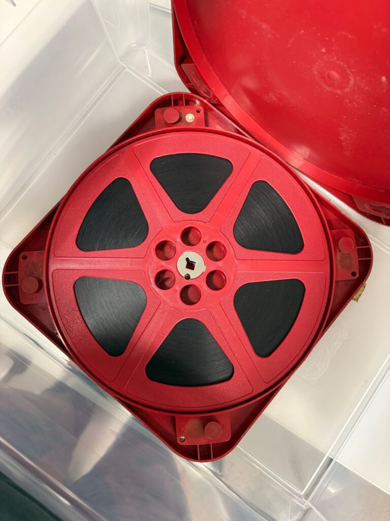 A 16mm film reel from the Börjesson collection in its original red case.