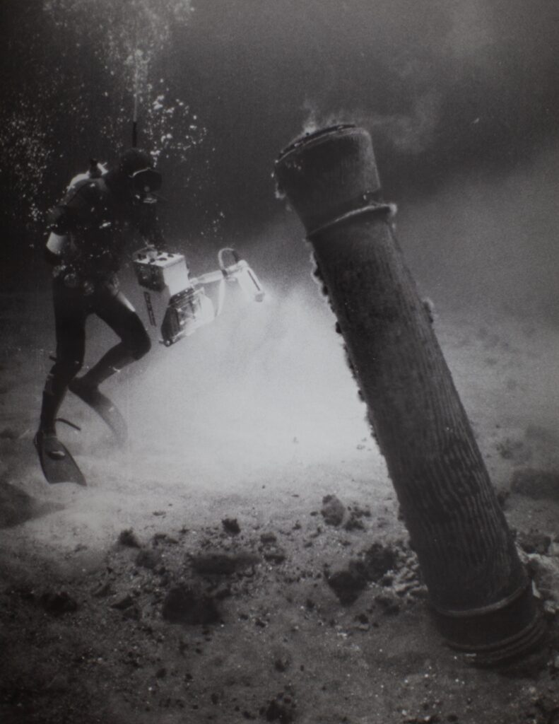 A diver documents the historic wreck of Kronan underwater.