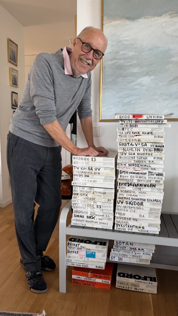 Archive albums from Kent Hult’s underwater photography collection are laid out